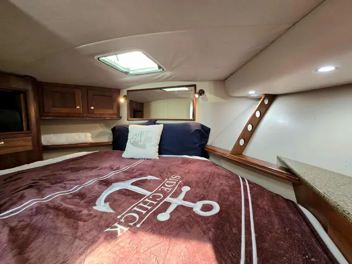 Side Chick Yacht Photos Pics Interior of 2002 Rampage 38 Express with cozy bed and skylights.
