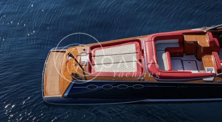 Temtation Yacht Photos Pics Luxurious 2011 J Craft Torpedo R 42 yacht with red seating on calm blue water.