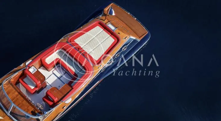 Temtation Yacht Photos Pics Luxurious 2011 J Craft Torpedo R 42 yacht with elegant red and white seating on deep blue water.