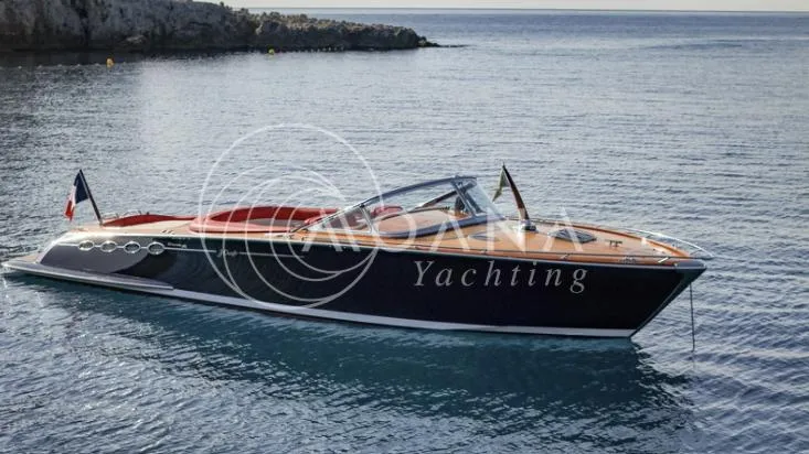 Temtation Yacht Photos Pics 2011 J Craft Torpedo R 42 yacht on calm sea near rocky coastline.