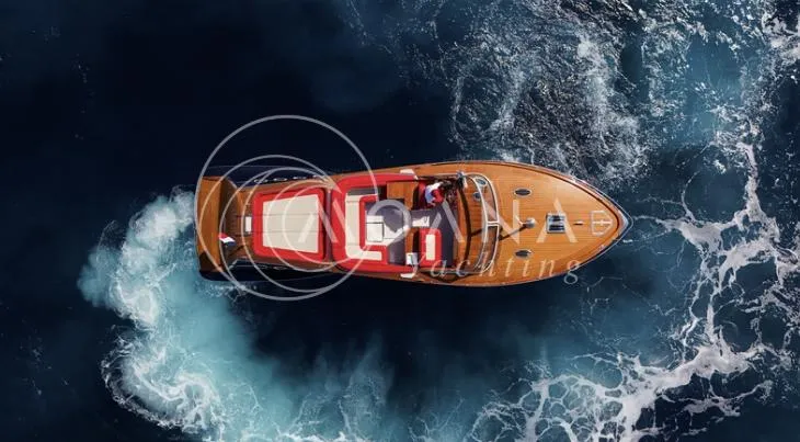 Temtation Yacht Photos Pics 2011 J Craft Torpedo R 42 yacht cruising on open water, aerial view.