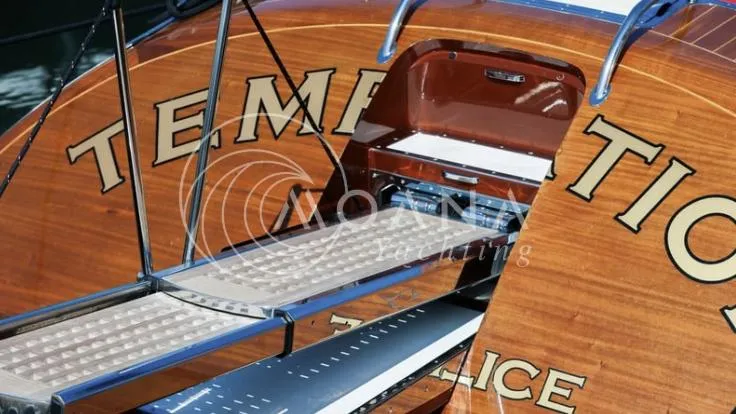 Temtation Yacht Photos Pics 2011 J Craft Torpedo R 42 yacht with open storage compartment and sleek wooden finish.