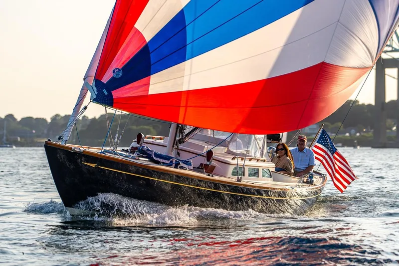 Tranquilo Yacht Photos Pics 2008 Morris Yachts M36 sailing with colorful spinnaker and American flag on a sunny day.