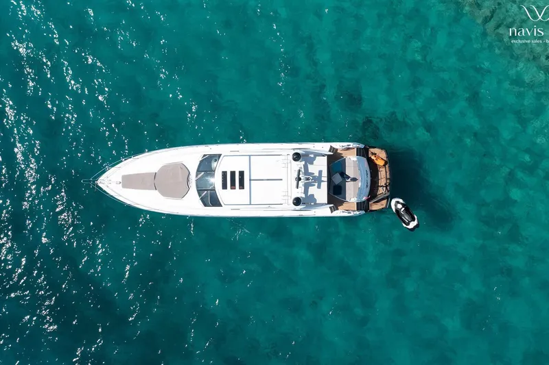  Yacht Photos Pics Aerial view of 2008 Sunseeker Predator 72 yacht on clear turquoise water.