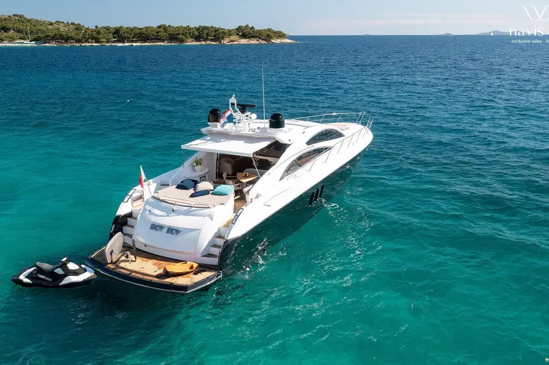  Yacht Photos Pics Luxury Sunseeker Predator 72 yacht, 2008 model, anchored in clear blue waters.