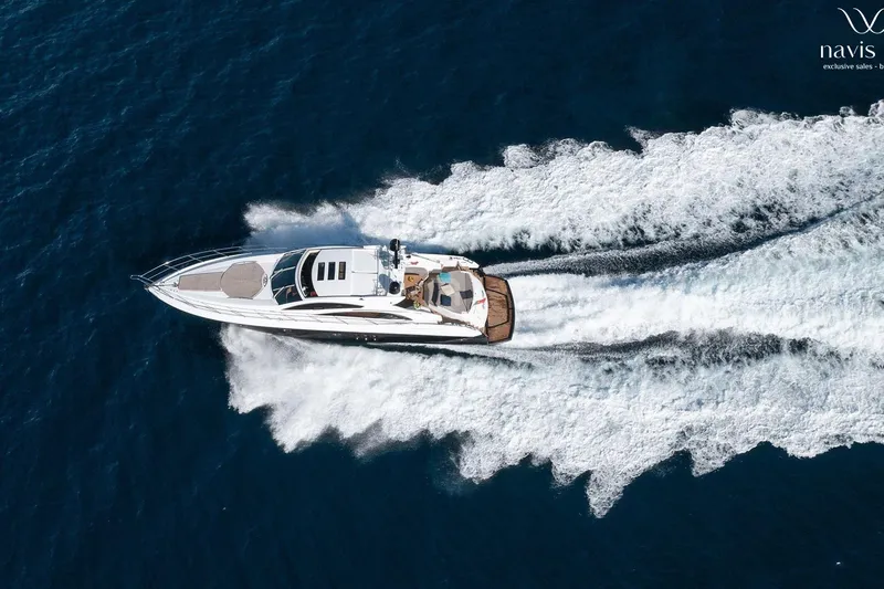  Yacht Photos Pics 2008 Sunseeker Predator 72 yacht cruising on open blue sea, aerial view.