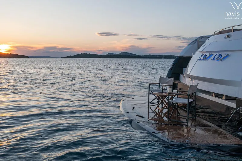  Yacht Photos Pics Sunseeker Predator 72 yacht at sunset, 2008 model, with chairs on deck.