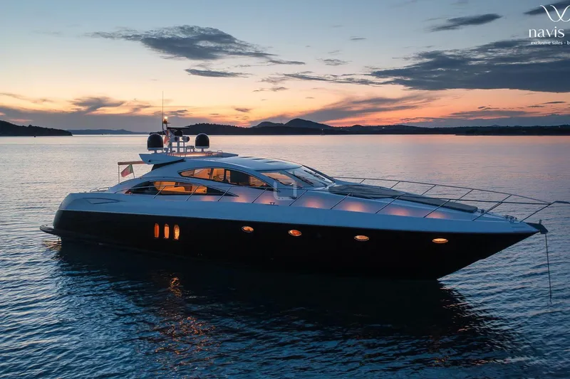  Yacht Photos Pics 2008 Sunseeker Predator 72 yacht at sunset on calm waters.