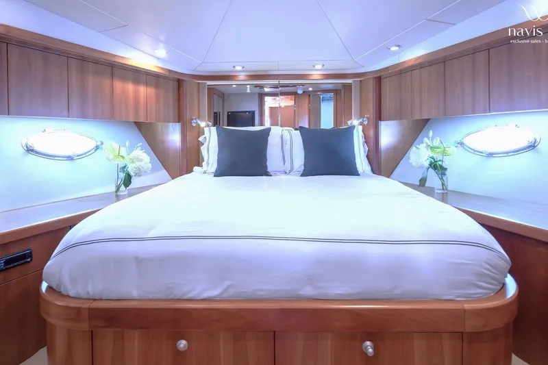  Yacht Photos Pics Luxurious bedroom interior of 2008 Sunseeker Predator 72 yacht with elegant wood finishes.