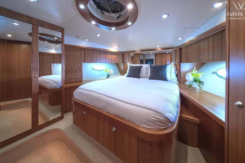  Yacht Photos Pics Luxurious bedroom interior of 2008 Sunseeker Predator 72 yacht with elegant wood finishes.