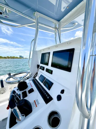 Relentless II W/ Seakeeper Yacht Photos Pics 2017 Contender 35 ST boat console with modern navigation equipment and ocean view.