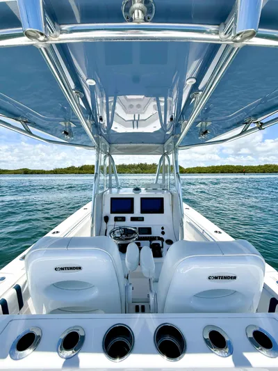 Relentless II W/ Seakeeper Yacht Photos Pics 2017 Contender 35 ST boat interior with dual seats and navigation controls on open water.