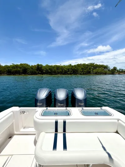 Relentless II W/ Seakeeper Yacht Photos Pics 2017 Contender 35 ST boat with triple engines on a serene lake.