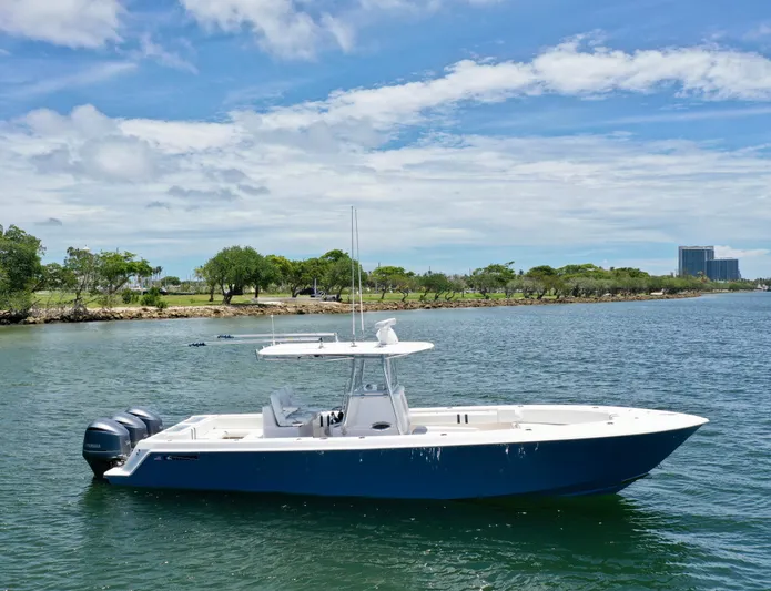 Relentless II W/ Seakeeper Yacht Photos Pics 2017 Contender 35 ST boat on calm water with scenic shoreline background.