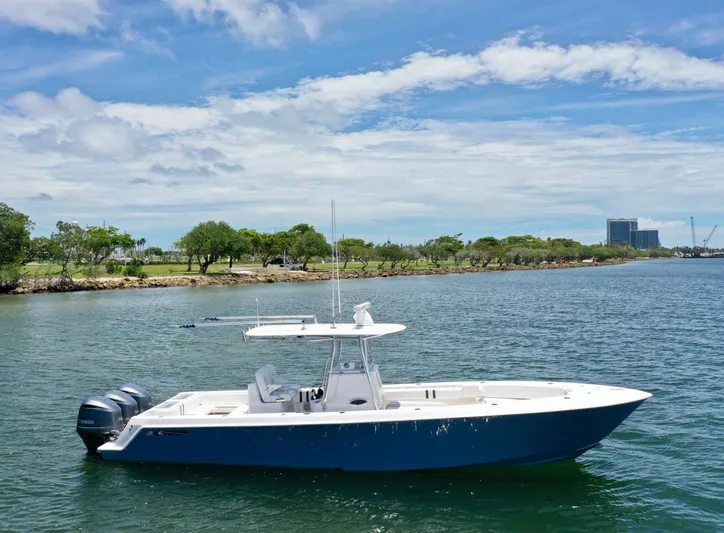Relentless II W/ Seakeeper Yacht Photos Pics 2017 Contender 35 ST boat on calm water under a clear blue sky.