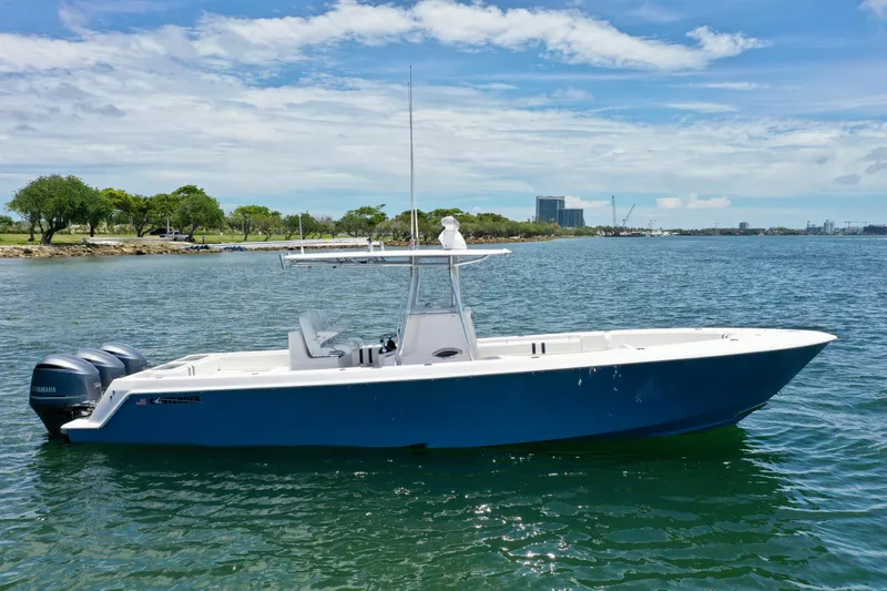 Relentless II W/ Seakeeper Yacht Photos Pics 2017 Contender 35 ST boat on calm water, clear sky, and distant shoreline.