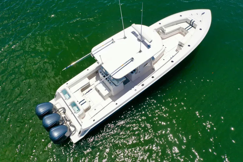 Relentless II W/ Seakeeper Yacht Photos Pics Aerial view of 2017 Contender 35 ST boat on green water.