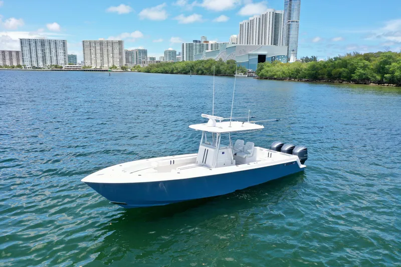 Relentless II W/ Seakeeper Yacht Photos Pics 2017 Contender 35 ST boat on water with city skyline in background.