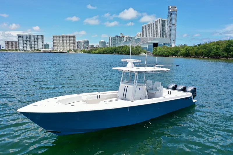 Relentless II W/ Seakeeper Yacht Photos Pics 2017 Contender 35 ST boat on water with city skyline in background.