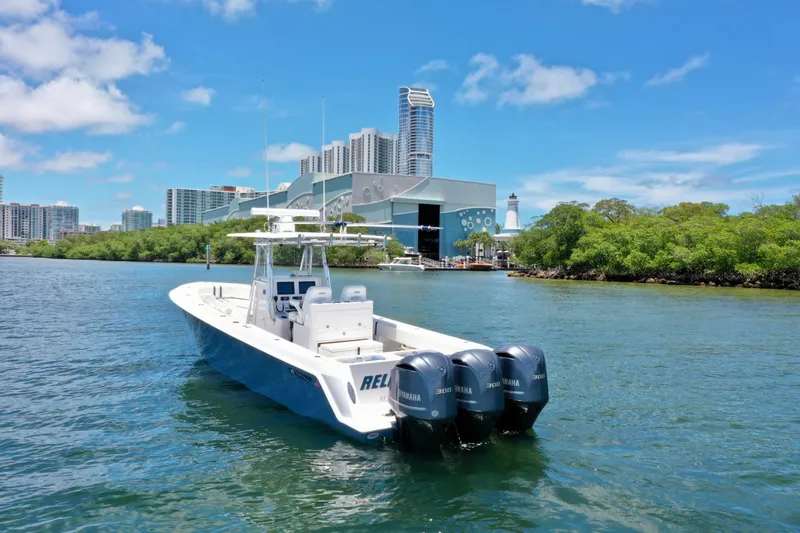 Relentless II W/ Seakeeper Yacht Photos Pics 2017 Contender 35 ST boat on water with cityscape and greenery in background.