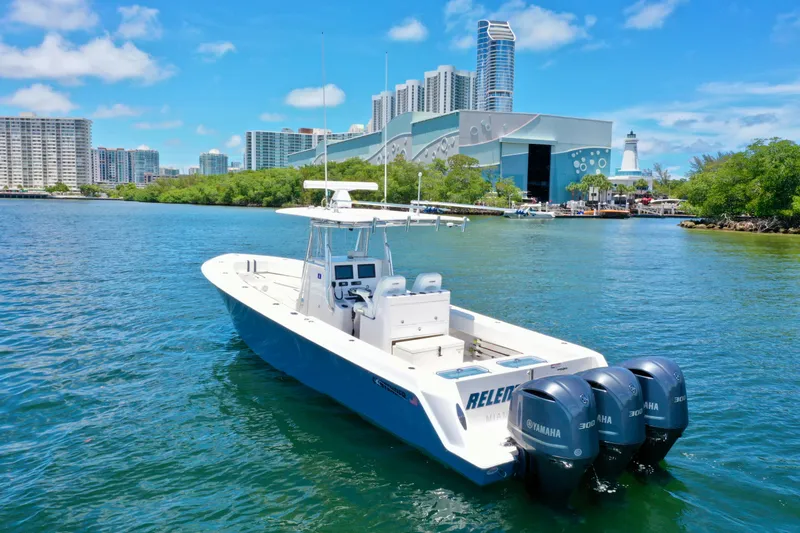 Relentless II W/ Seakeeper Yacht Photos Pics 2017 Contender 35 ST boat with triple Yamaha engines on a sunny waterfront.