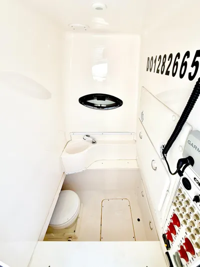 Relentless II W/ Seakeeper Yacht Photos Pics 2017 Contender 35 ST boat interior with white cabin, toilet, and equipment.