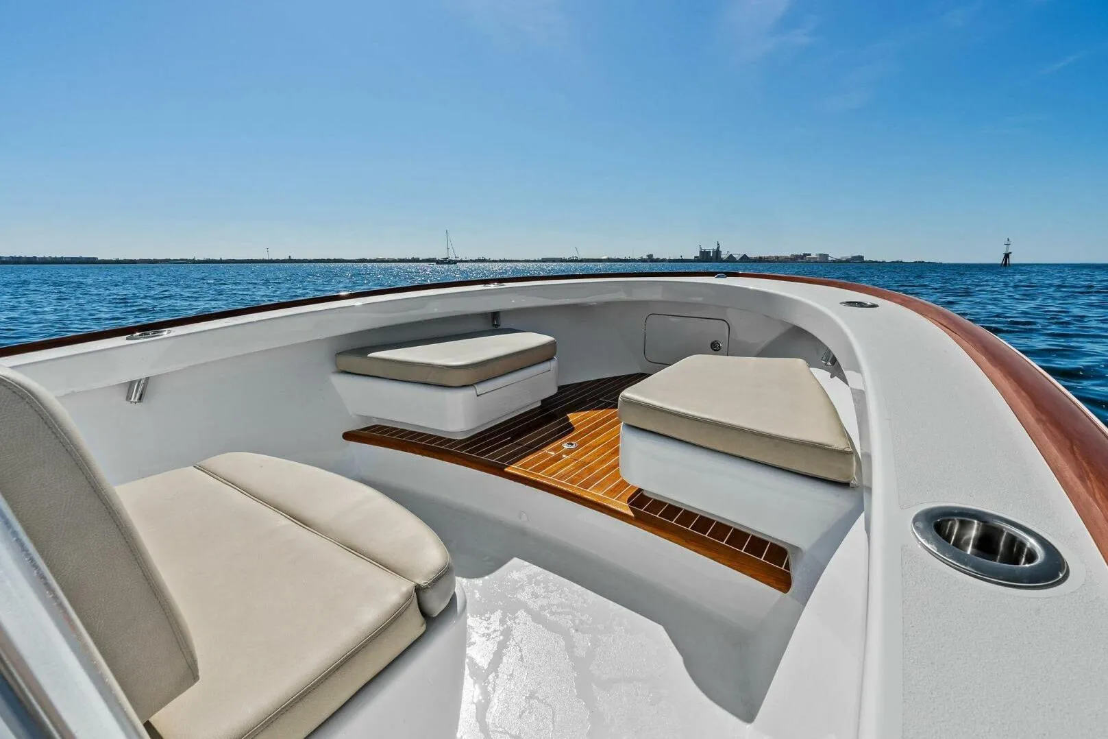 2024 Custom Center Console High Ground Boatworks on open water, featuring cushioned seating.