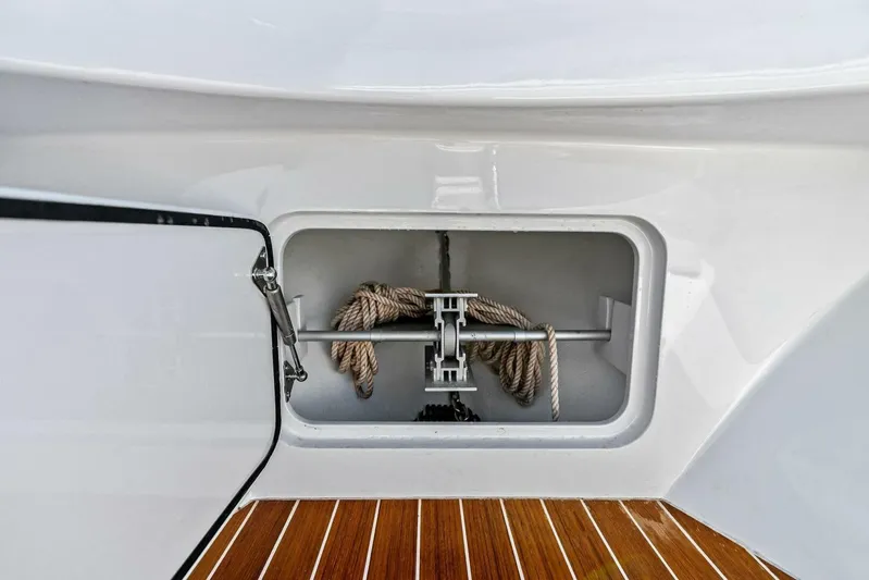  Yacht Photos Pics 2024 Custom Center Console High Ground Boatworks anchor storage with rope on teak deck.