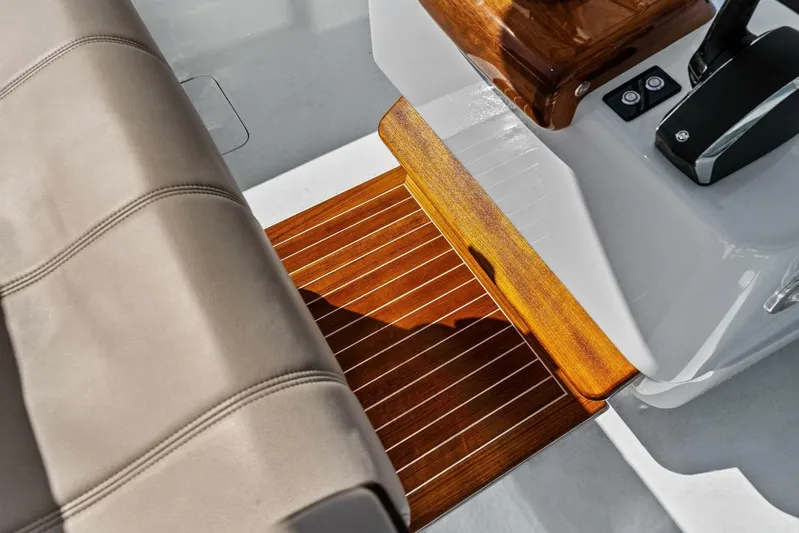  Yacht Photos Pics 2024 Custom Center Console High Ground Boatworks interior with wood accents and controls.