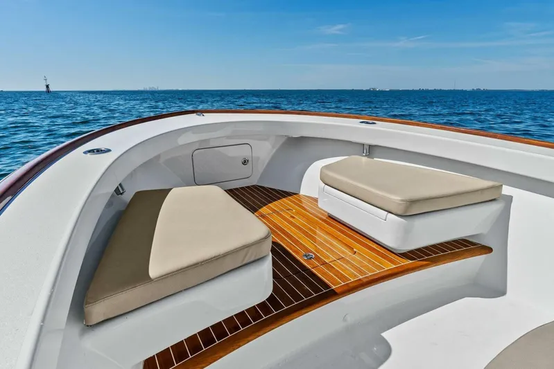  Yacht Photos Pics 2024 Custom Center Console High Ground Boatworks on open water, featuring cushioned seating.