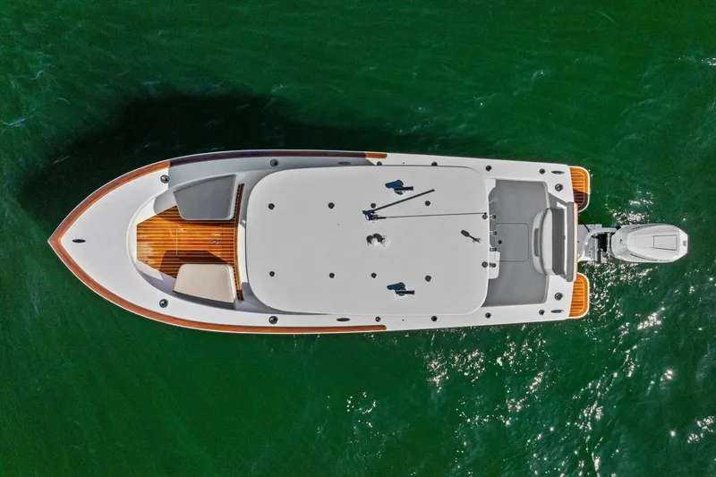  Yacht Photos Pics Aerial view of 2024 Custom Center Console High Ground Boatworks on green water.