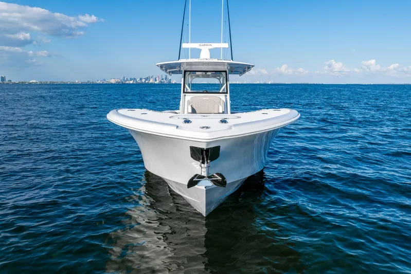  Yacht Photos Pics 2024 Yellowfin 39 boat on open water, clear sky, city skyline in background.