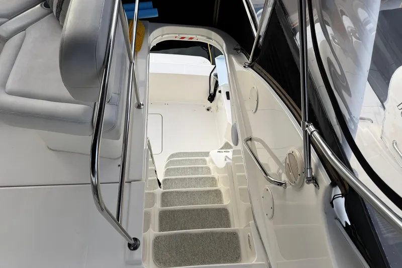 Stormer Yacht Photos Pics Interior view of 2005 Silverton 34 Convertible yacht staircase and seating area.
