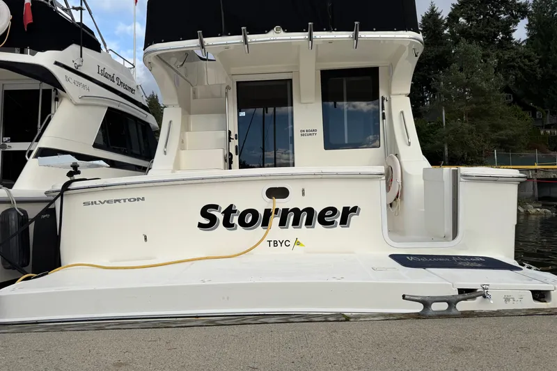 Stormer Yacht Photos Pics 2005 Silverton 34 Convertible boat docked, featuring "Stormer" name on the stern.
