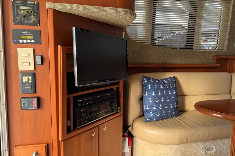 Stormer Yacht Photos Pics Interior of 2005 Silverton 34 Convertible yacht with TV, control panel, and seating area.