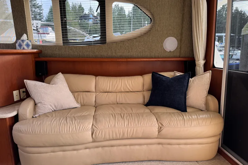 Stormer Yacht Photos Pics Interior of 2005 Silverton 34 Convertible with beige leather sofa and decorative pillows.