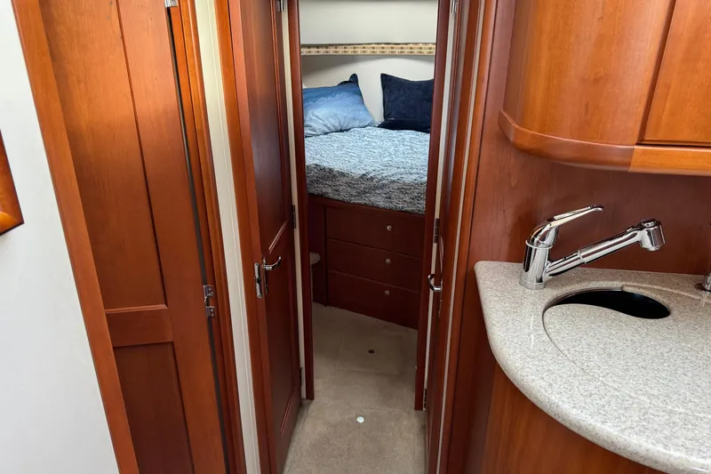 Stormer Yacht Photos Pics 2005 Silverton 34 Convertible yacht interior with wood cabinetry and compact sink.