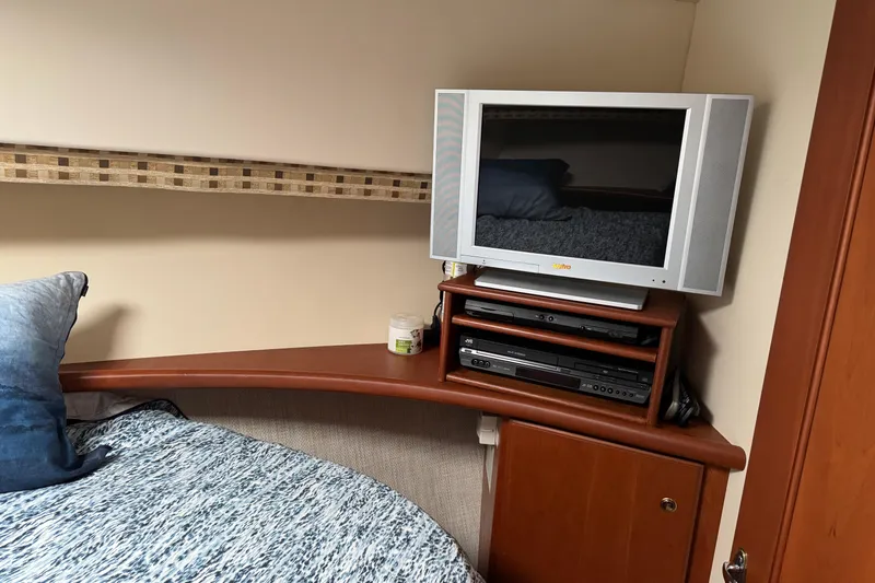 Stormer Yacht Photos Pics 2005 Silverton 34 Convertible cabin with TV, DVD player, and cozy bedding.