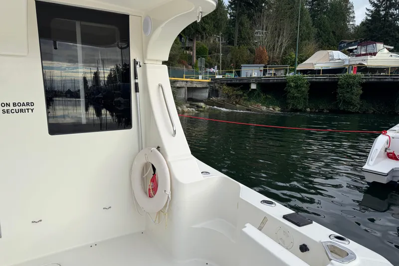 Stormer Yacht Photos Pics 2005 Silverton 34 Convertible boat docked near a scenic waterfront.