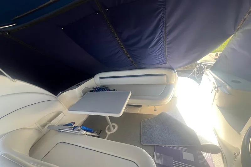  Yacht Photos Pics Interior of 2005 Sea Ray 360 Sundancer with seating and table under canopy.