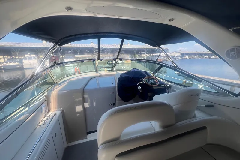  Yacht Photos Pics 2005 Sea Ray 360 Sundancer cockpit with marina view, featuring sleek design and comfortable seating.