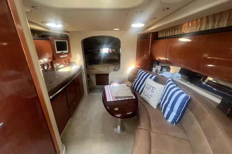  Yacht Photos Pics Luxurious interior of a 2005 Sea Ray 360 Sundancer yacht with cozy seating and elegant wood finishes.