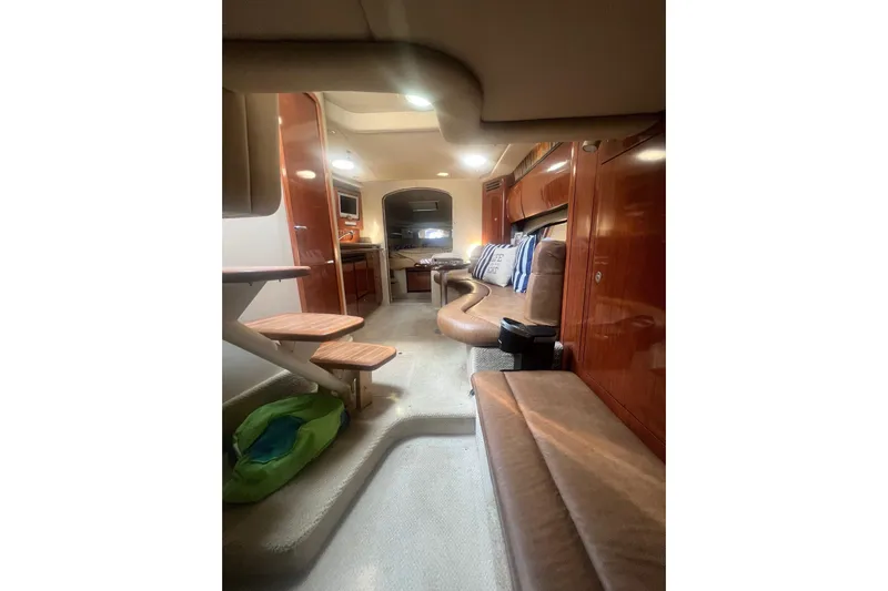  Yacht Photos Pics Interior of 2005 Sea Ray 360 Sundancer yacht, featuring luxurious seating and wooden cabinetry.