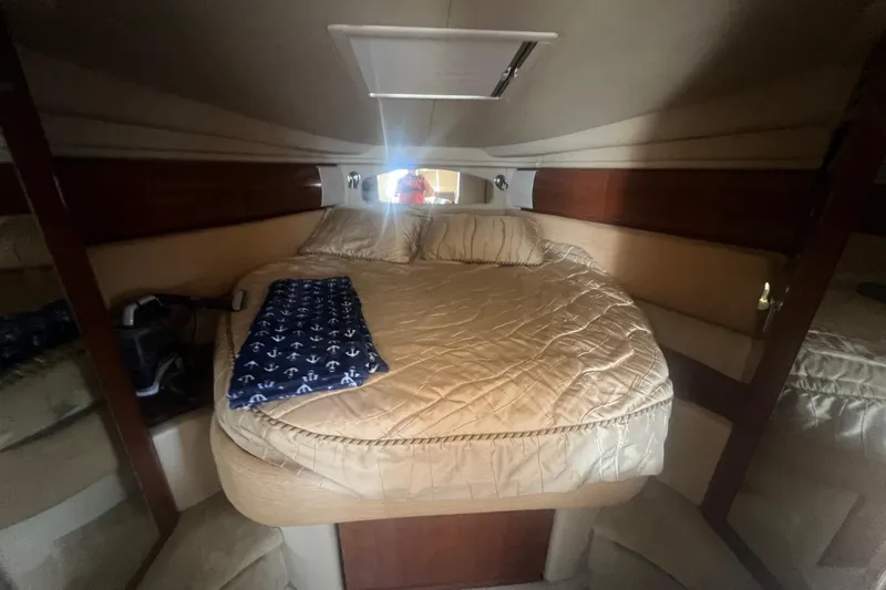  Yacht Photos Pics Cozy cabin interior of 2005 Sea Ray 360 Sundancer yacht with bed and nautical decor.