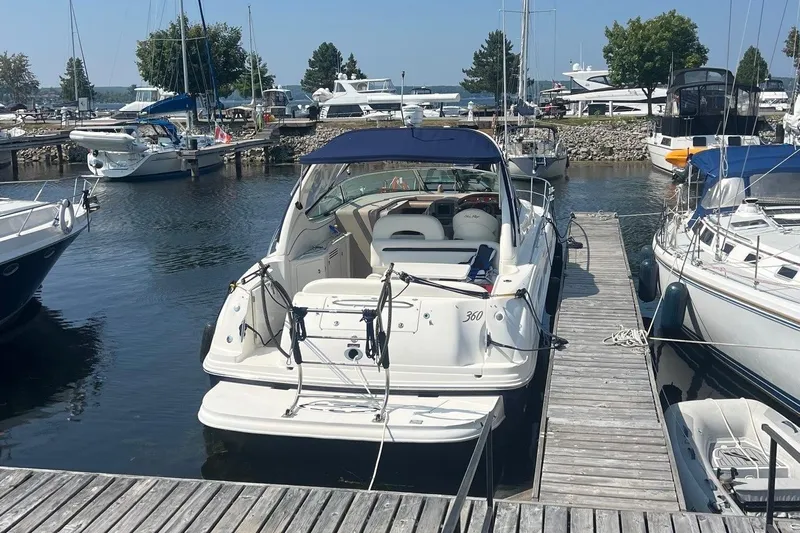  Yacht Photos Pics 2005 Sea Ray 360 Sundancer docked at marina, surrounded by other boats.