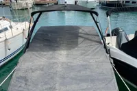 2007 Cobalt 232 boat with cover docked in marina.