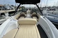 2007 Cobalt 232 boat with beige seating, docked at a marina.