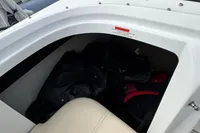 Storage compartment in a 2007 Cobalt 232 boat with life jackets inside.