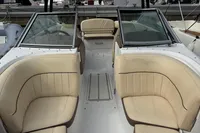 2007 Cobalt 232 boat interior with beige seating and dual windshields at a marina.