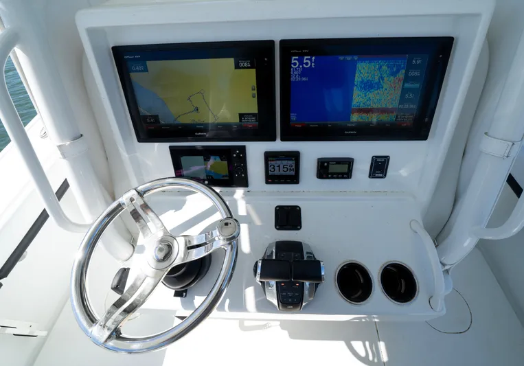  Yacht Photos Pics 2018 Yellowfin 32 Offshore boat dashboard with dual screens and steering wheel.